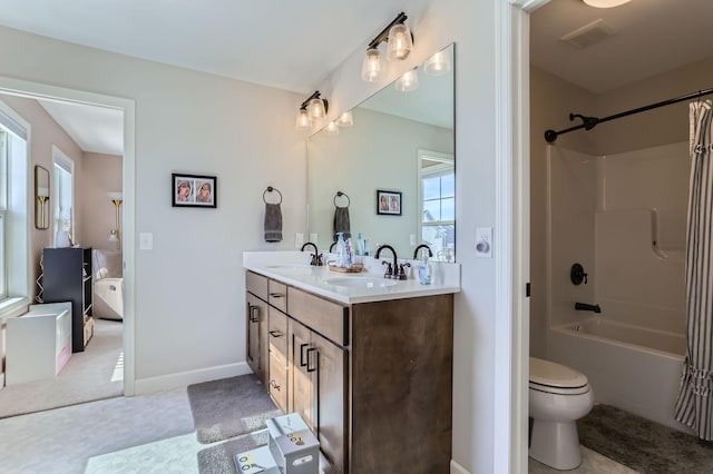 bathroom with double vanity, shower / tub combination, visible vents, and a sink