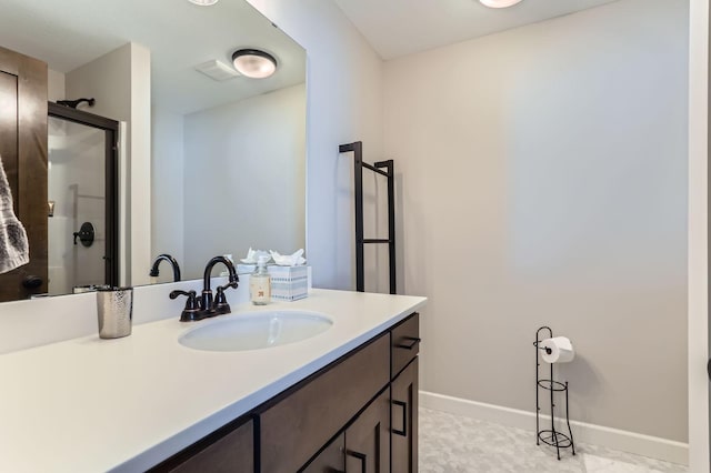 full bathroom featuring vanity, a shower stall, visible vents, and baseboards