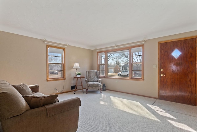 living room featuring carpet flooring, a healthy amount of sunlight, and baseboards