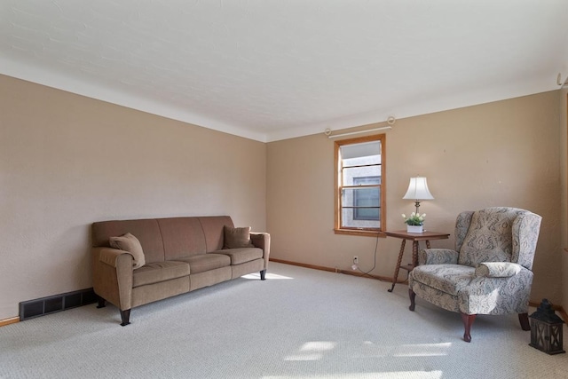 carpeted living area with visible vents and baseboards