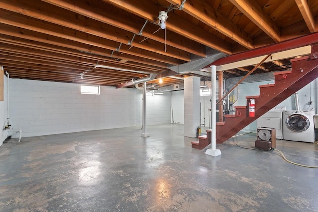 basement featuring stairway and separate washer and dryer