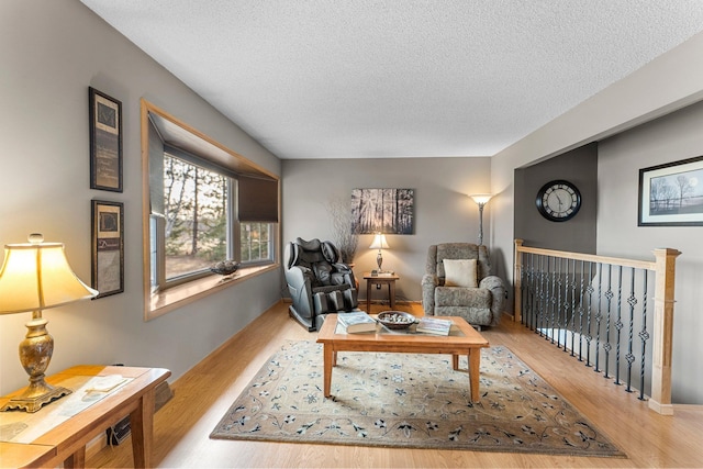 living room with wood finished floors and a textured ceiling