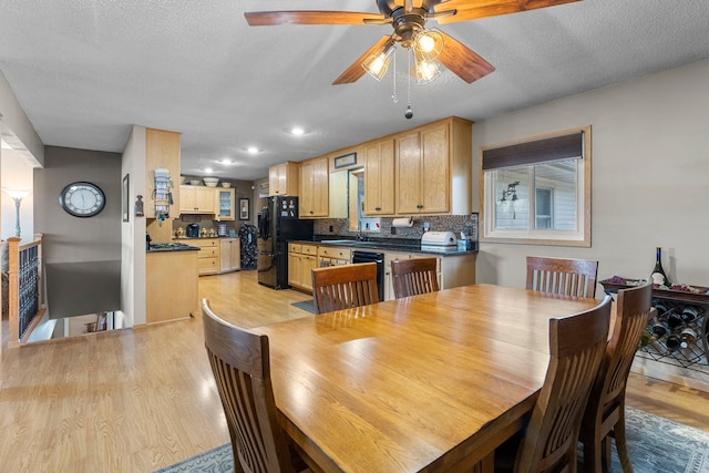 dining room featuring recessed lighting, a textured ceiling, and light wood-type flooring