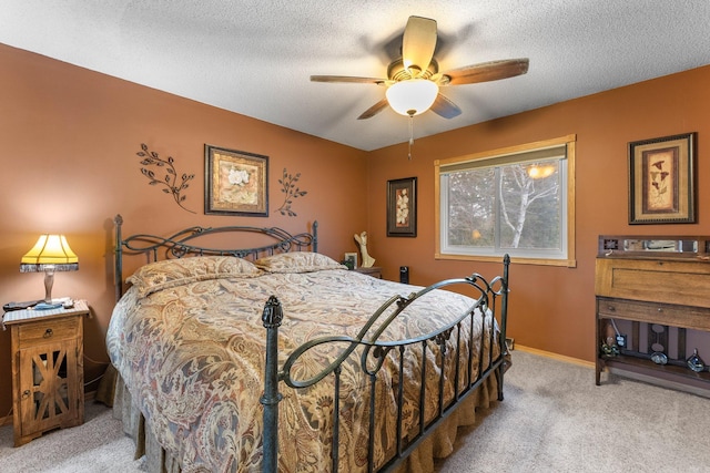 carpeted bedroom with baseboards, a textured ceiling, and ceiling fan