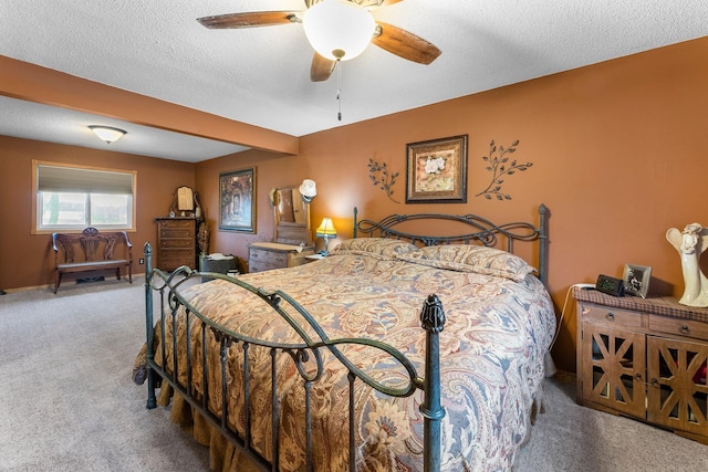 bedroom featuring carpet, a ceiling fan, and a textured ceiling