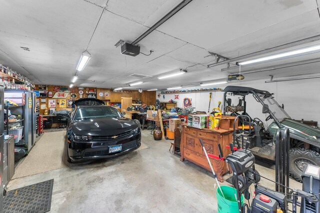 garage with a workshop area and a garage door opener