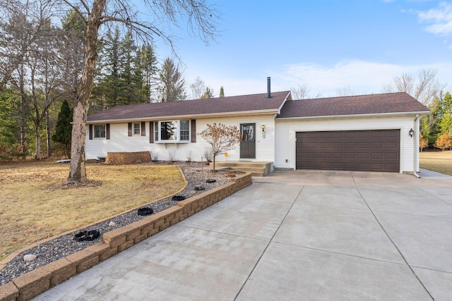 single story home with concrete driveway and a garage