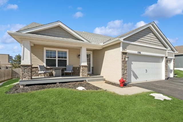 view of front of house with a porch, a garage, roof with shingles, and aphalt driveway