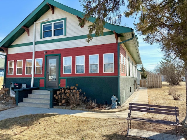 view of front of property featuring stucco siding and fence