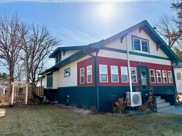 view of home's exterior featuring ac unit and a yard