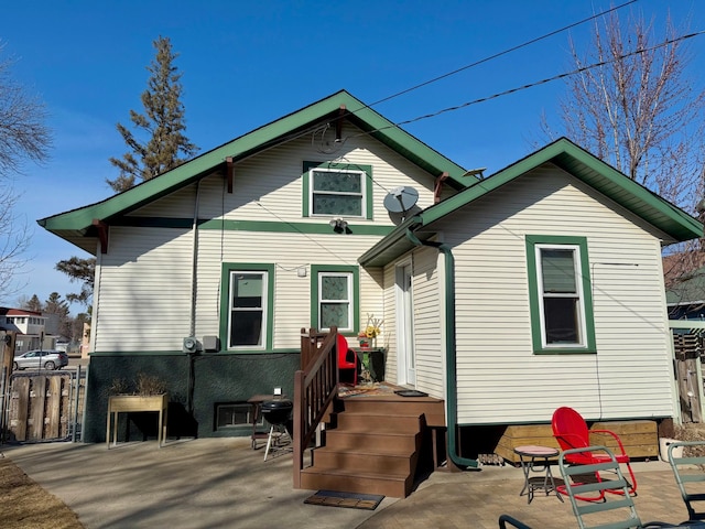 rear view of house featuring a patio area and fence