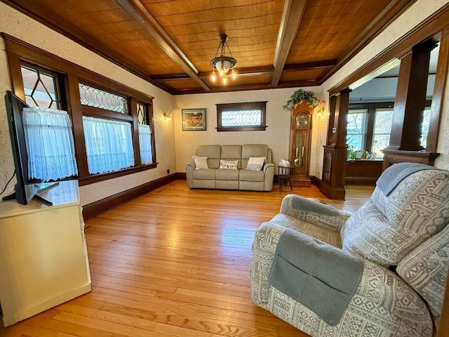 living area with baseboards, ornate columns, light wood-style flooring, wood ceiling, and beamed ceiling