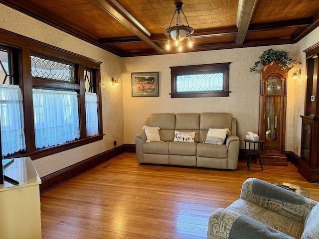 living area featuring wood ceiling, coffered ceiling, a textured wall, and wood-type flooring