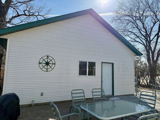 exterior space with a patio, outdoor dining space, and fence