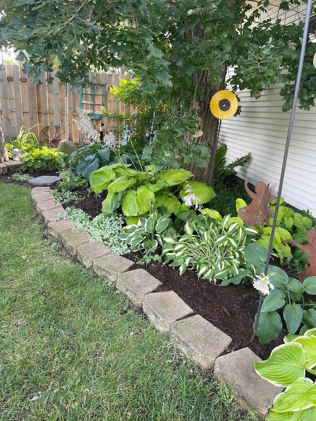 view of yard with a garden pond and fence