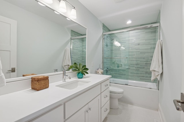 bathroom featuring tile patterned floors, toilet, vanity, and bath / shower combo with glass door