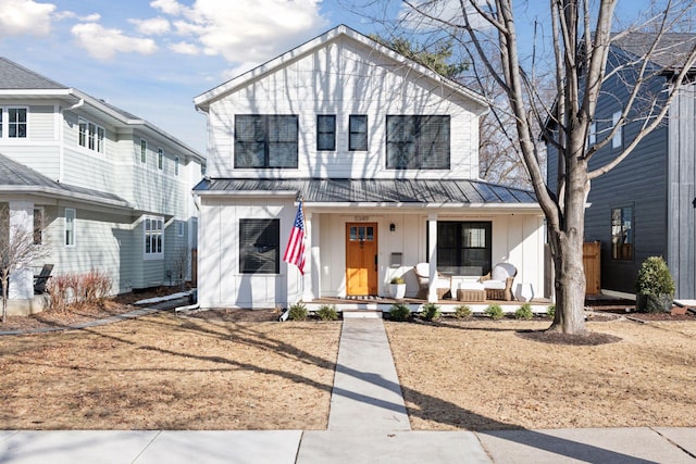 view of front of property with a porch, metal roof, a standing seam roof, and board and batten siding