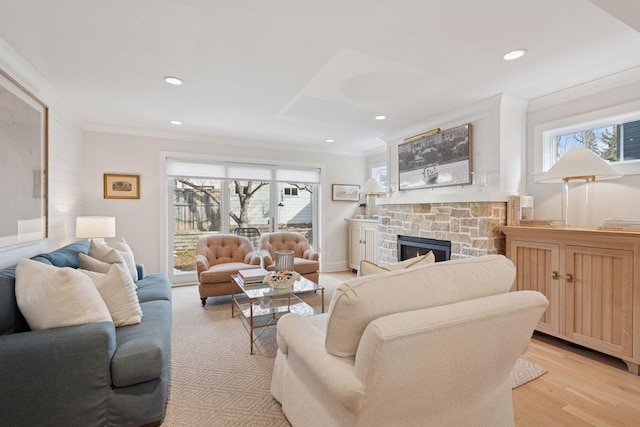 living room with recessed lighting, a fireplace, light wood finished floors, and ornamental molding