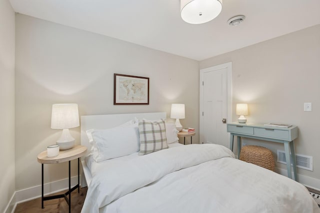 bedroom featuring visible vents and baseboards