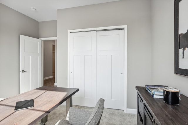 office featuring light carpet and baseboards