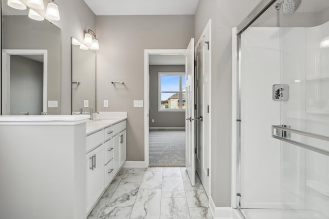 full bath featuring baseboards, marble finish floor, a stall shower, and vanity