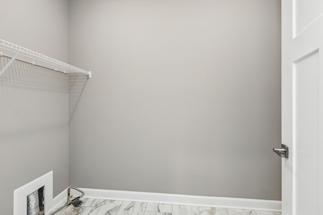 washroom with baseboards and marble finish floor