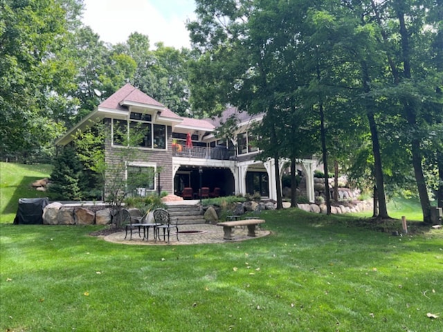 back of house with a patio, a lawn, and a wooden deck