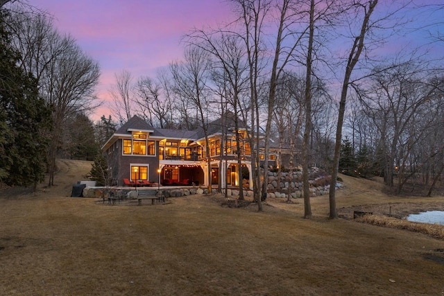 back of property featuring a patio and a lawn