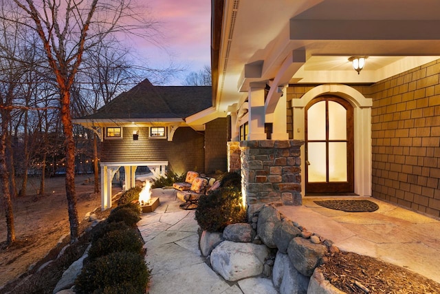 exterior entry at dusk with stucco siding