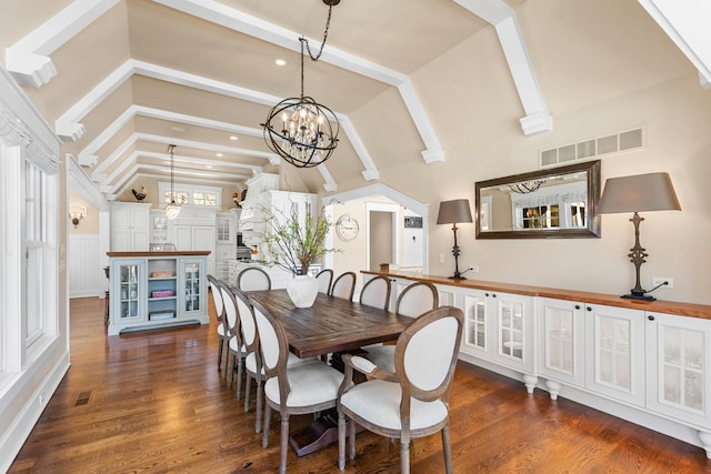 dining space featuring a notable chandelier, visible vents, and dark wood-style flooring