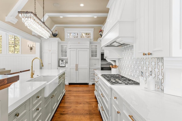 kitchen featuring stainless steel gas cooktop, plenty of natural light, built in refrigerator, and a sink