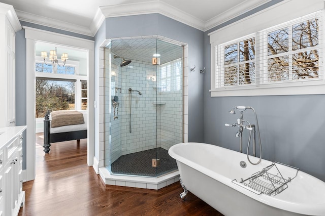 bathroom featuring plenty of natural light, a shower stall, wood finished floors, and crown molding