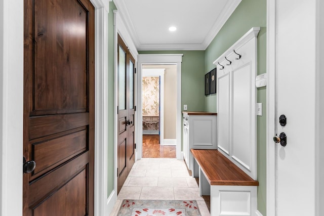 mudroom with baseboards, light tile patterned flooring, and crown molding