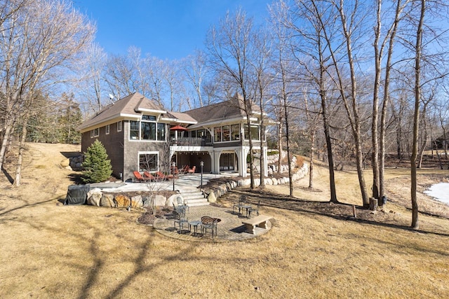 rear view of house with stairway, a lawn, a deck, and a patio area