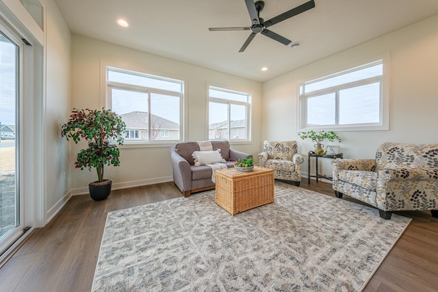 living area with a ceiling fan, recessed lighting, wood finished floors, and baseboards