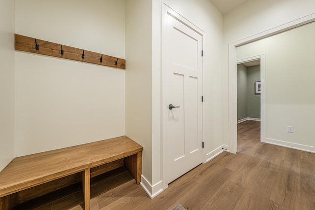 mudroom with wood finished floors and baseboards