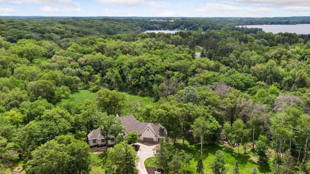 bird's eye view with a water view and a wooded view