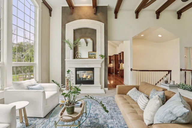 living room with a multi sided fireplace and beam ceiling