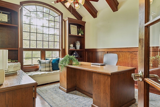 office area featuring wainscoting, lofted ceiling with beams, ceiling fan, and wood finished floors