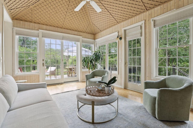 sunroom featuring a healthy amount of sunlight, wooden ceiling, ceiling fan, and vaulted ceiling