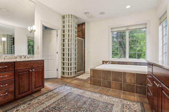 full bathroom featuring vanity, a bath, a stall shower, and ornamental molding