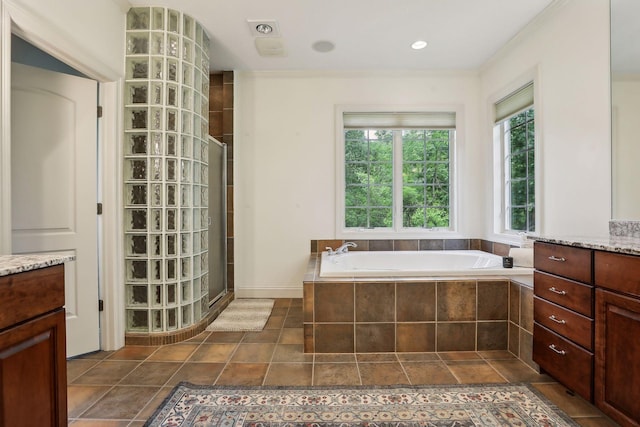 full bathroom featuring tile patterned flooring, a bath, vanity, and a tile shower