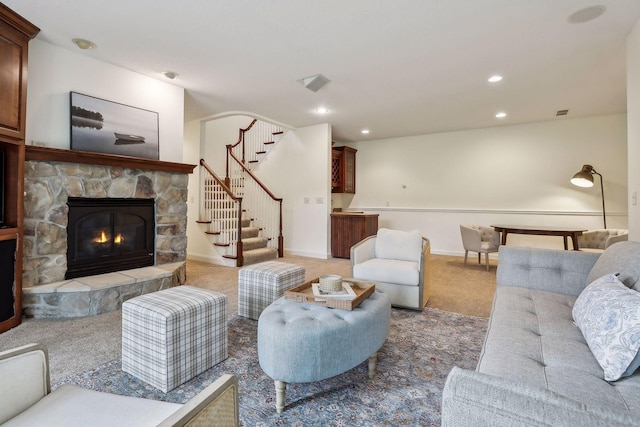 living area with stairway, baseboards, recessed lighting, a fireplace, and light carpet