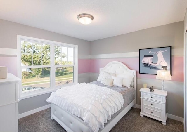 bedroom featuring baseboards and dark colored carpet