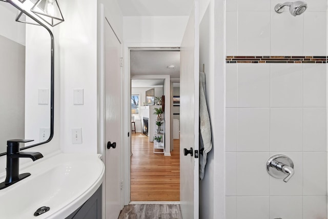 bathroom with vanity, wood finished floors, and walk in shower