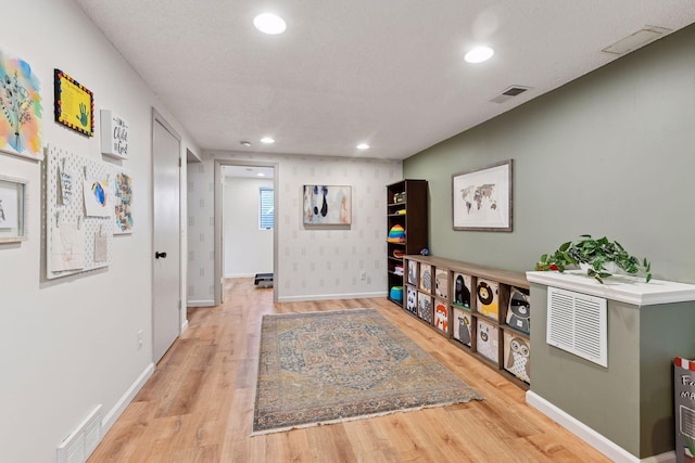 interior space featuring recessed lighting, wood finished floors, and visible vents