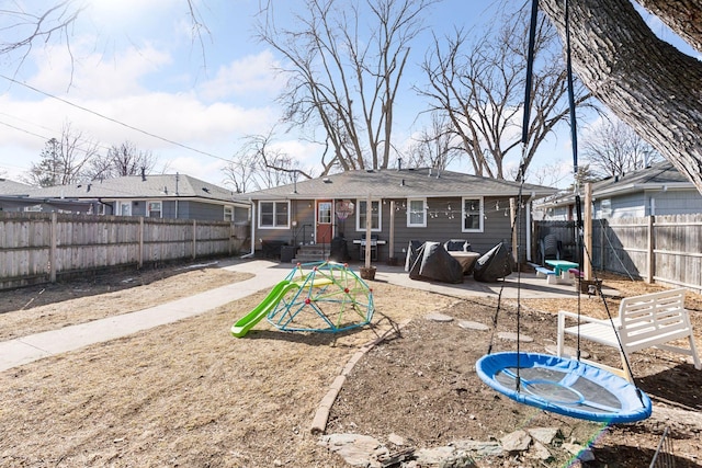 rear view of house with a patio and a fenced backyard