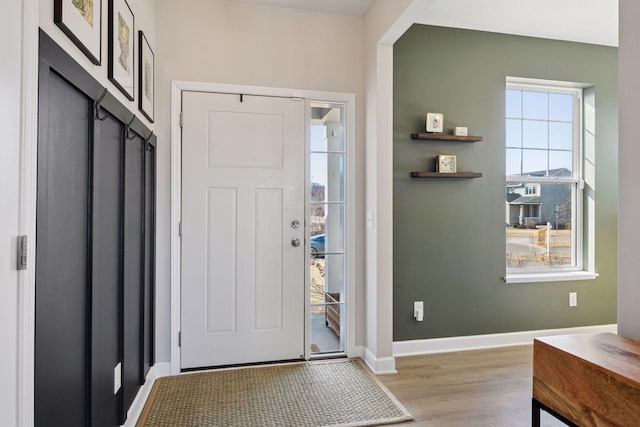 foyer entrance featuring light wood-type flooring and baseboards