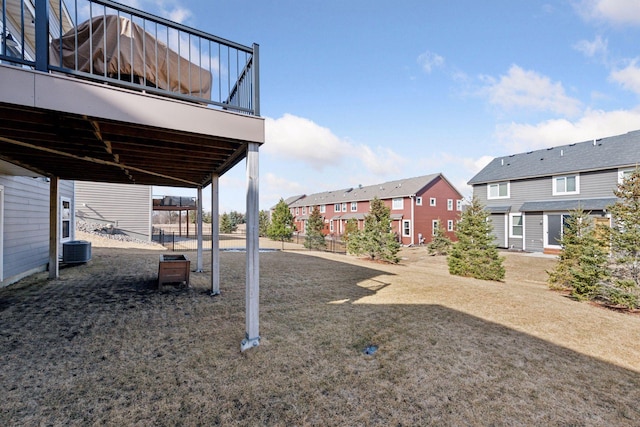 view of yard with a residential view and central AC unit