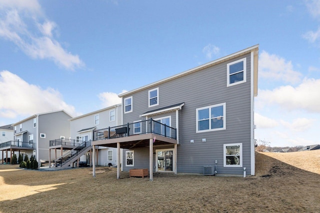 rear view of property with a deck, stairway, and central AC unit